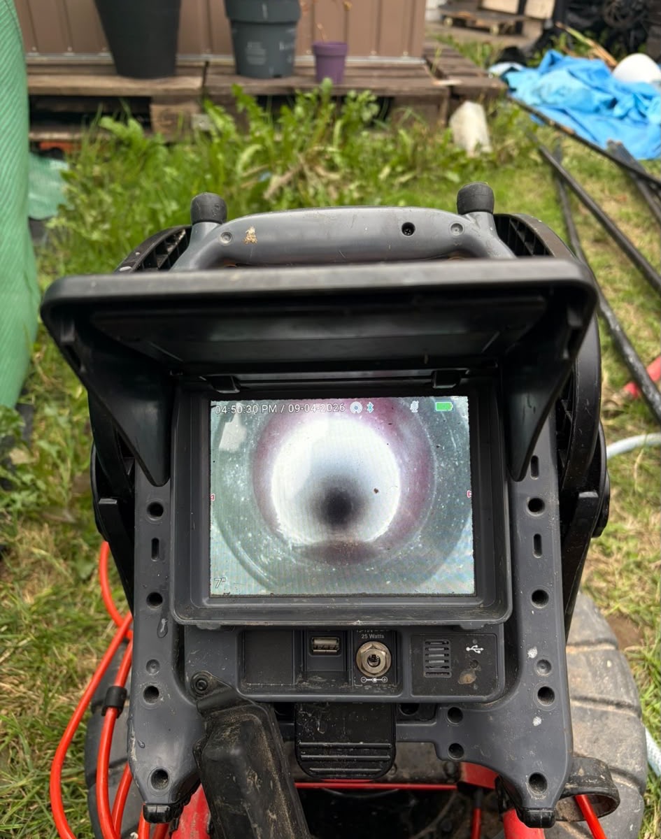 Drain inspection monitor showing a relined pipe